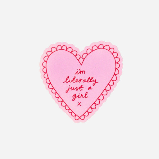A pink heart-shaped sticker with a scalloped border and the text 'I'm literally just a girl x' in dark pink script, shown on a plain light gray background.